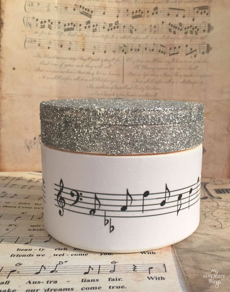 How to make a DIY Christmas Gift out of an old container using some glitter and music paper | Via www.sweethings.net
