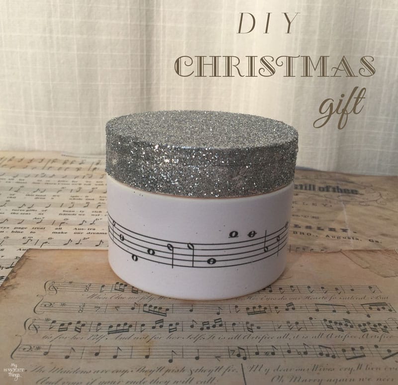 How to make a DIY Christmas Gift out of an old container using some glitter and music paper | Via www.sweethings.net