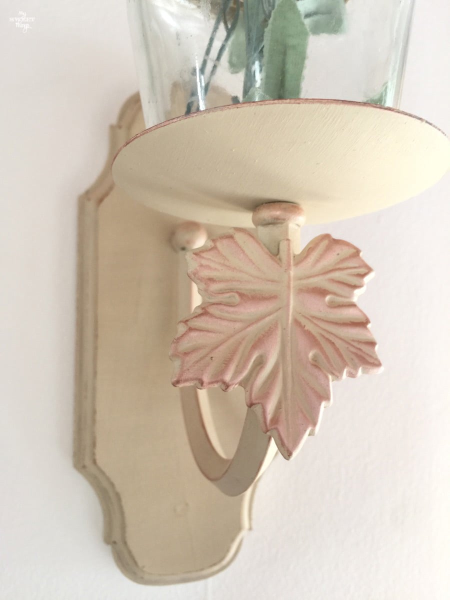 Light wall sconce repurposed into candle wall sconce with just some paint and an empty jar · Via www.sweethings.net